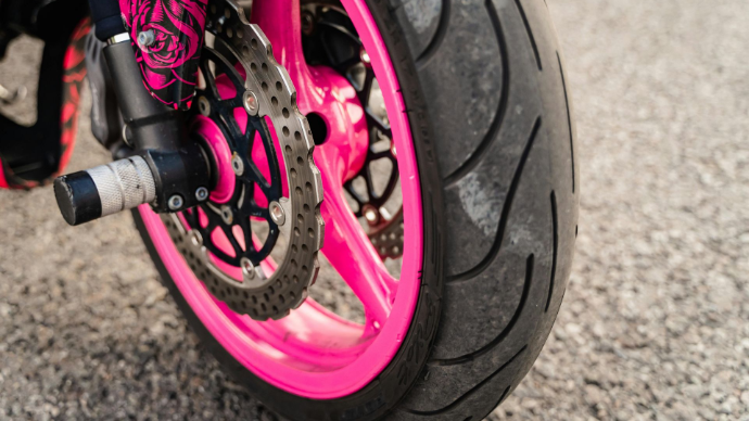 Pink rim with tire on stunt bike