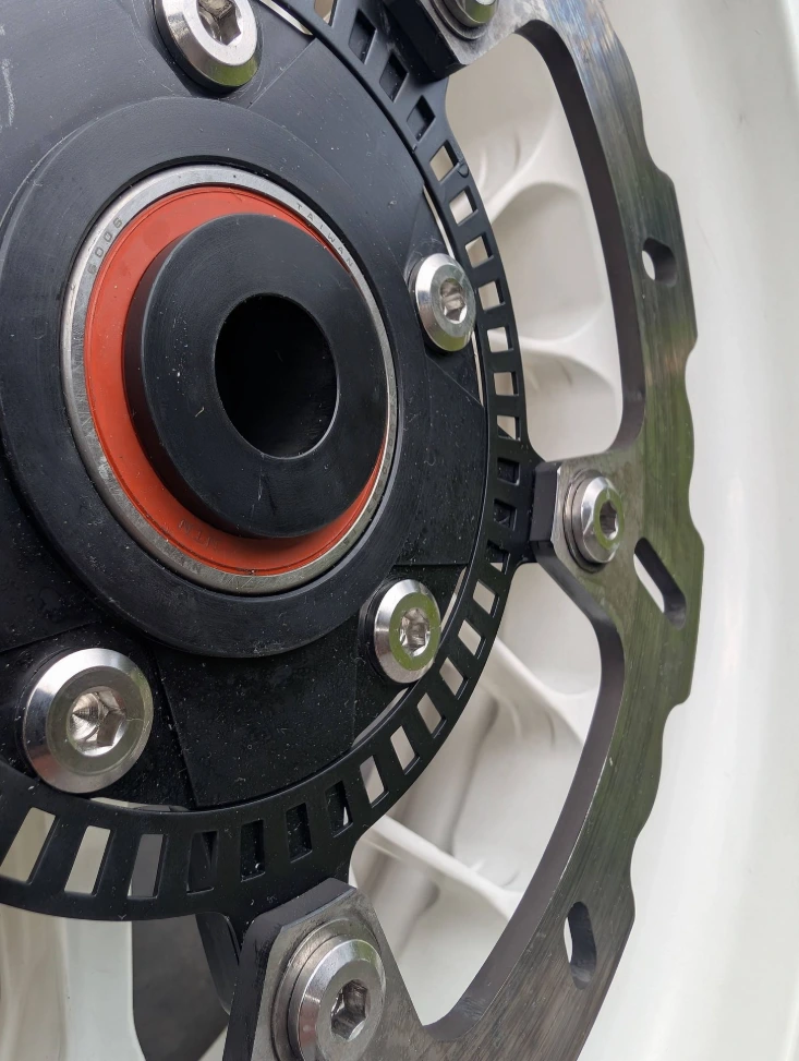 Detail of the machined brake disc carrier with sensor ring in the PVM 10Y rear wheel for a Husqvarna Nuda