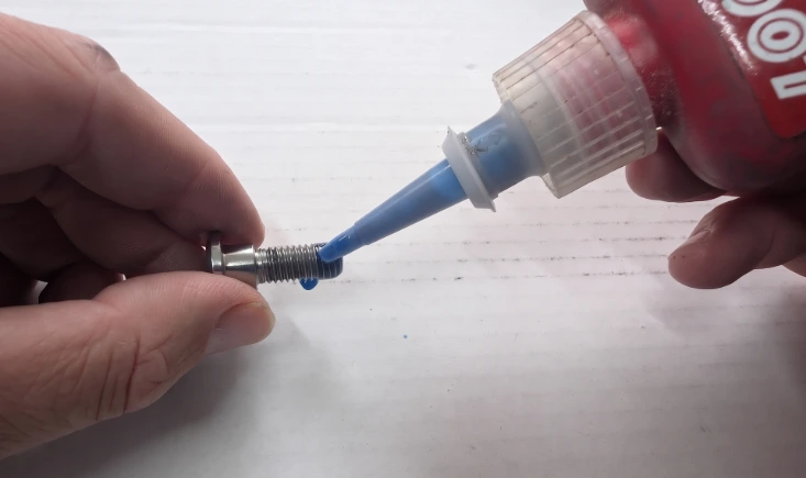 Applying threadlocker to a wheel bolt